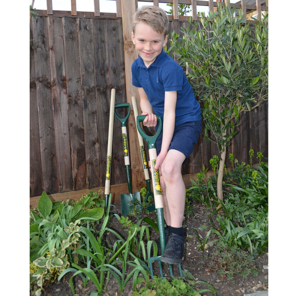 Child using Bulldog kids garden fork for digging