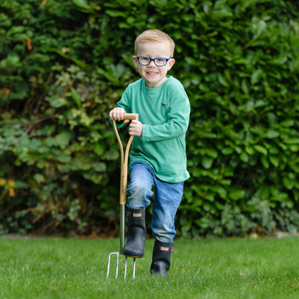 Boy with a Kent and Stowe digging fork for children gardening