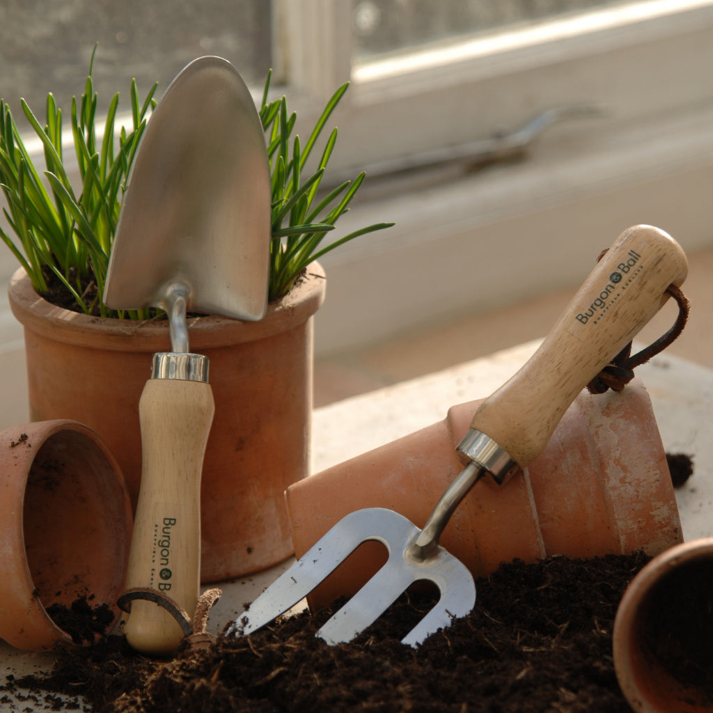 Burgon and Ball hand trowel and fork being used to plant