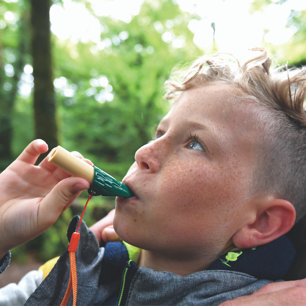 Boy using whistle from the Hape kids explorer kit
