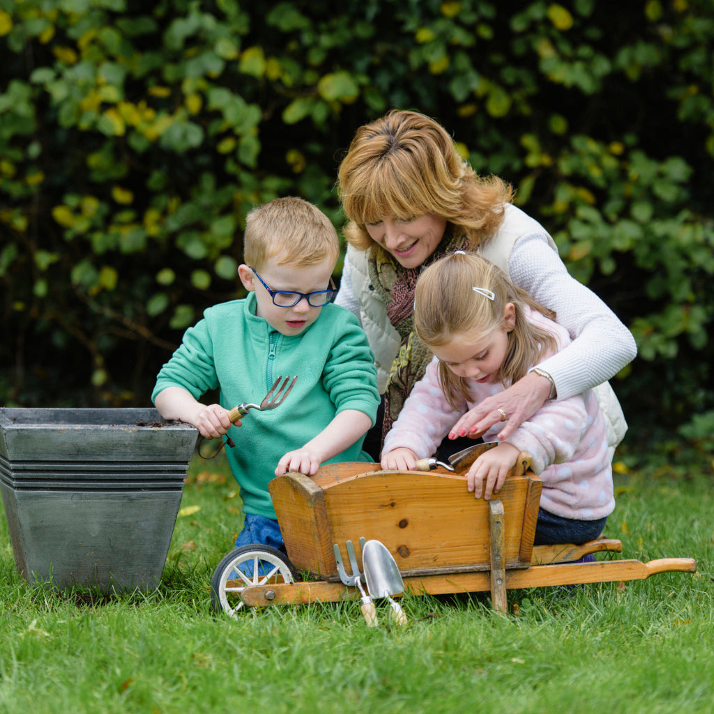 Mum and children using Kent and Stowe Gardening tolls for children