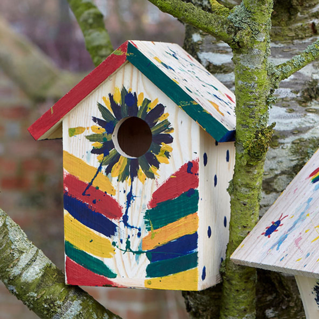 Decorated example in the garden of Paint Your Own Birdhouse.