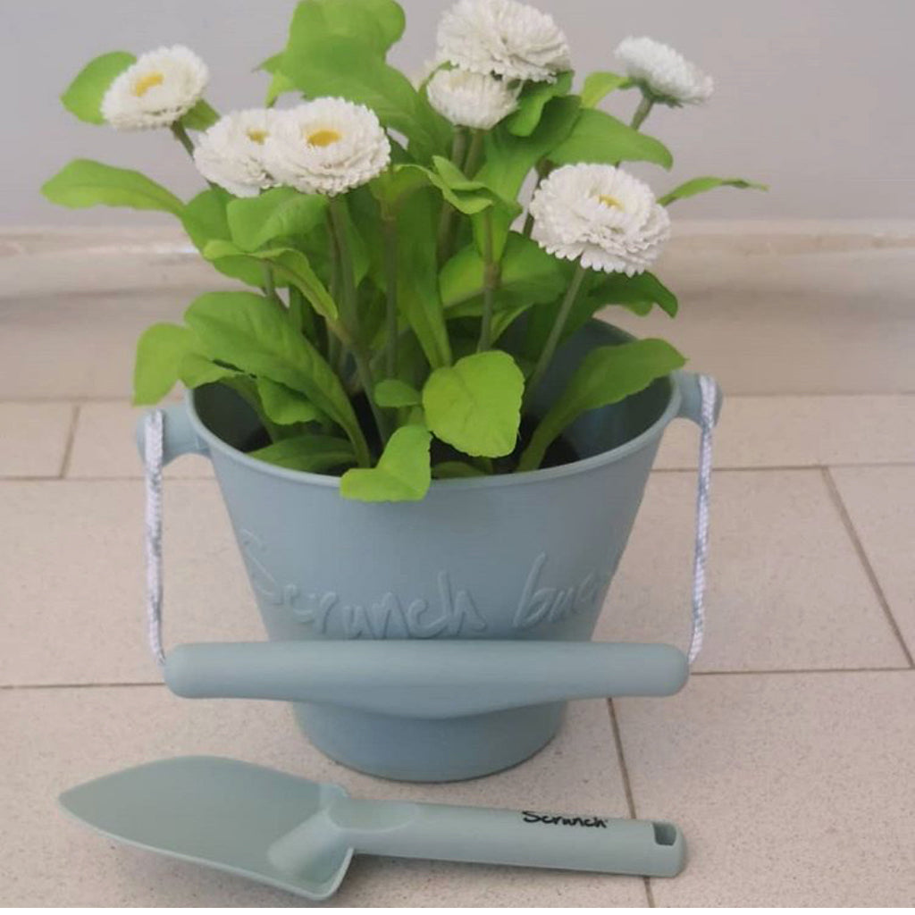 Scrunch bucket used as a plant pot with a Scrunch hand spade