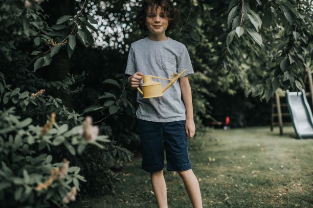 Boy using The Langley Sprinkler Watering Can in yellow